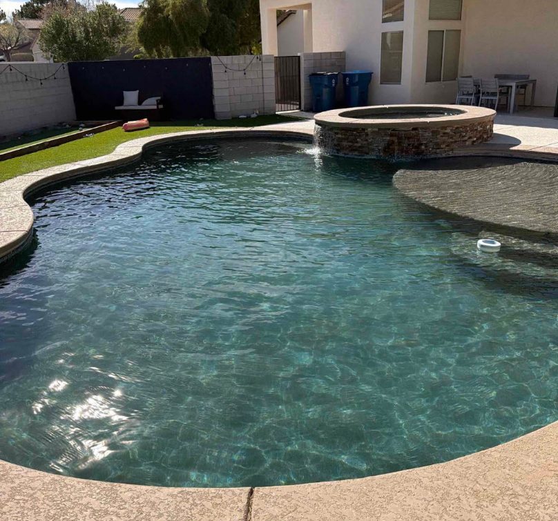 Freeform pool with attached spa, clean and balanced after weekly service