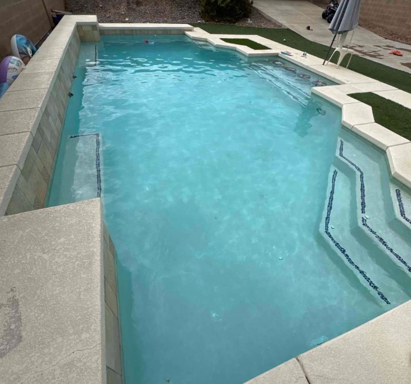 Sparkling clean rectangular pool with steps after a Summit Pool Services visit